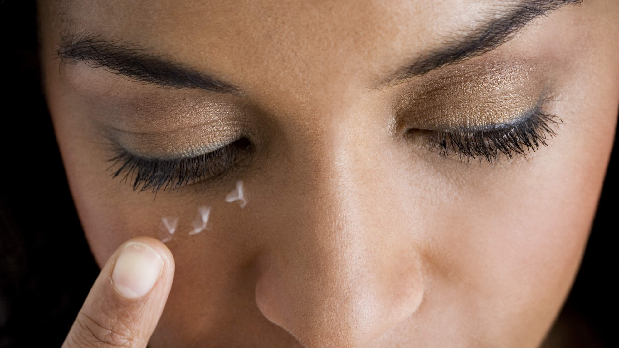 Woman Applying Eye Cream